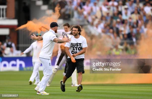 Ben Stokes of England attempts to stop a "Just Stop Oil" protester during Day One of the LV= Insurance Ashes 2nd Test match between England and...