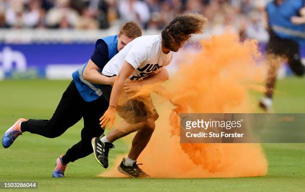 Just Stop Oil" protester is tackled by security during Day One of the LV= Insurance Ashes 2nd Test match between England and Australia at Lord's...