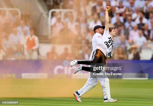 Jonny Bairstow of England removes a "Just Stop Oil" pitch invader during Day One of the LV= Insurance Ashes 2nd Test match between England and...