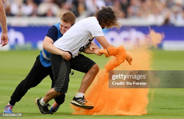 Just Stop Oil" protester is tackled by security during Day One of the LV= Insurance Ashes 2nd Test match between England and Australia at Lord's...