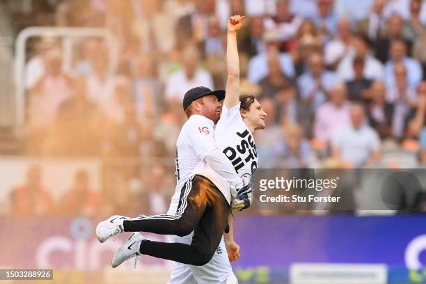 Jonny Bairstow of England removes a "Just Stop Oil" pitch invader during Day One of the LV= Insurance Ashes 2nd Test match between England and...