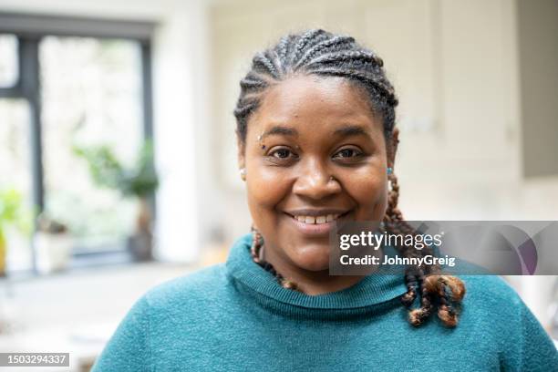 indoor portrait of multiracial woman with braided hair - eyebrow piercing stock pictures, royalty-free photos & images