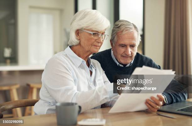 retirement, life insurance paperwork and old couple with policy and planning with security and finance. savings, bills and budget, elderly woman and man at home with legal documents and pension plan - legal assistance stock pictures, royalty-free photos & images