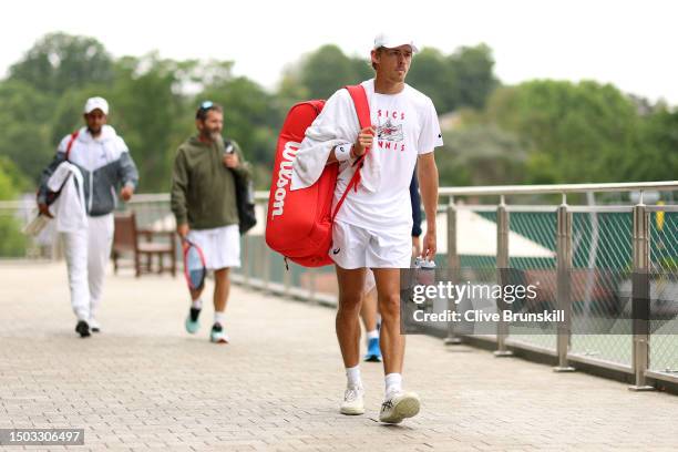 Alex De Minaur of Australia heads back after a practice session following rainfall ahead of The Championships - Wimbledon 2023 at All England Lawn...