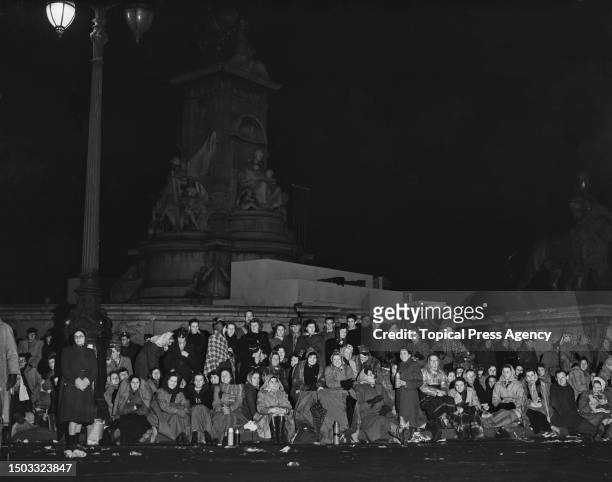 Crowds waiting through the night by the Victoria Memorial outside Buckingham Palace to watch the wedding procession of Princess Elizabeth , and...