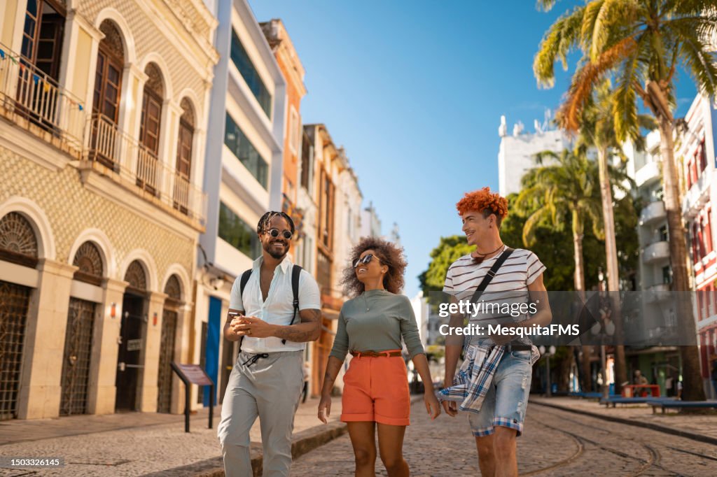 Friends walking on Rua do Bom Jesus in Recife city