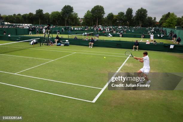 General view as Luca Nardi of Italy plays a backhand against Taro Daniel of Japan during The Championships - Wimbledon 2023 Qualifying at Roehampton...