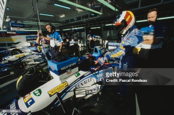 Michael Schumacher from Germany prepares to climb aboard the Mild Seven Benetton Renault Benetton B195 Renault RS7 V10 inside the pit garage before...