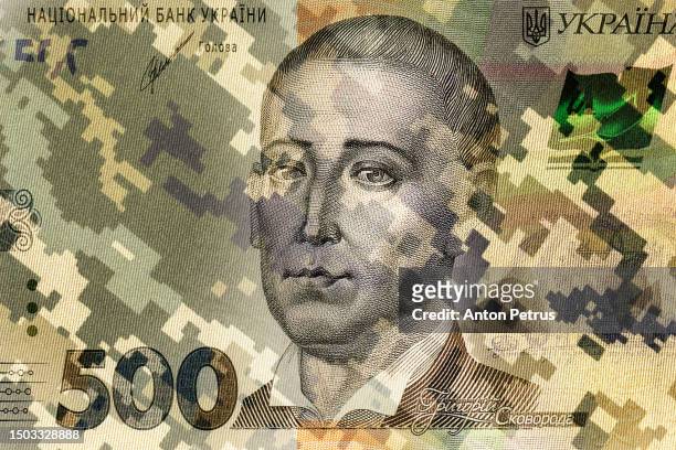 camouflage of the ukrainian army against the background of a banknote of 500 hryvnia - conflict stock pictures, royalty-free photos & images