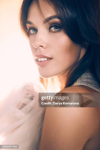 close up of the young woman with wedding dress near the wardrobe. the young woman dreaming about future wedding or prom with copy space. - posh people with big teeth stock pictures, royalty-free photos & images