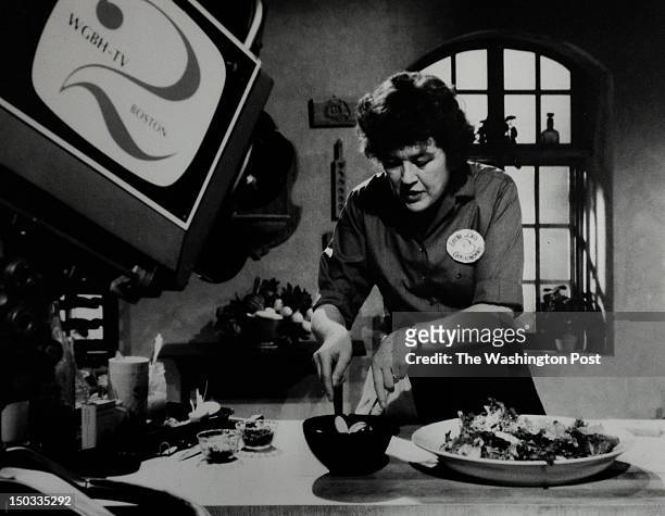 On display is a vintage photo of Julia Child taping a TV show in her kitchen. The Julia Child kitchen display is re-opening in November after being...