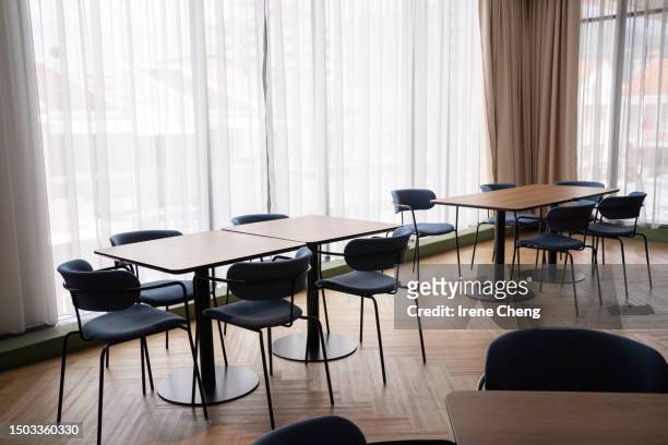 dining table chair of the modern design cafe. cafe interior - empty desk stock pictures, royalty-free photos & images