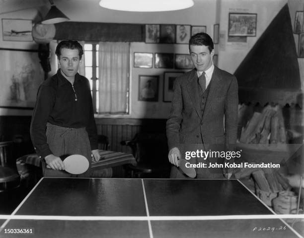 American actors and friends Henry Fonda and James Stewart play a game of table tennis, 1937.