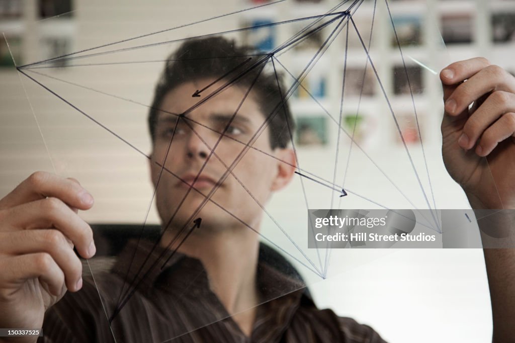 Mixed race businessman looking at diagram