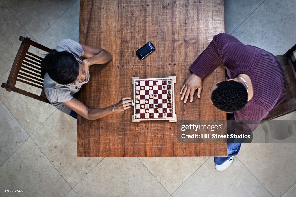 Couple playing chess together