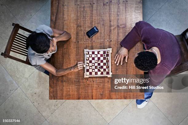 couple playing chess together - chess board overhead stock pictures, royalty-free photos & images