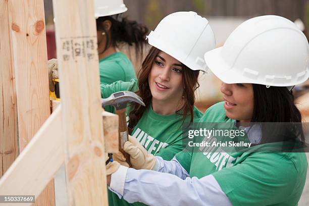 volunteers working on construction site - volunteer building stock pictures, royalty-free photos & images