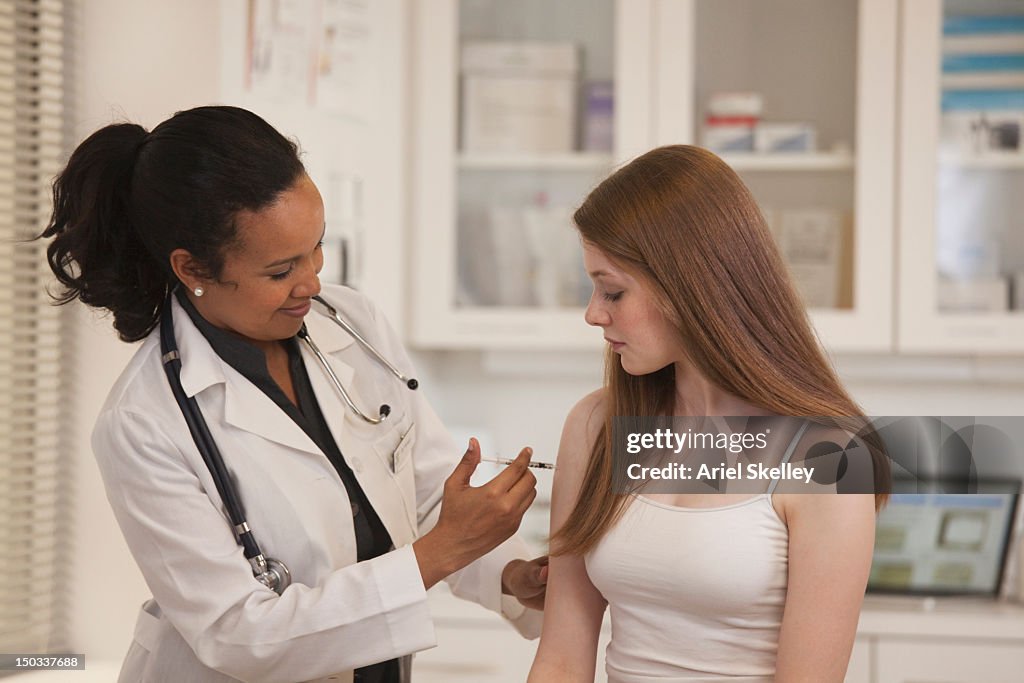 Doctor giving patient vaccination