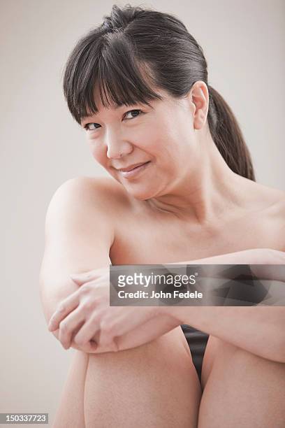 smiling asian woman - hugging knees stock pictures, royalty-free photos & images