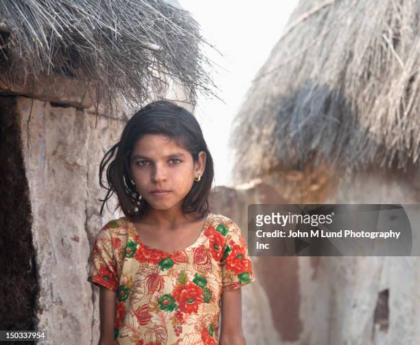 serious indian girl near thatched hut, rajasthan india - rajasthani youth stock pictures, royalty-free photos & images