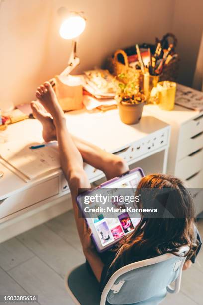 girls using digital tablet phone in children's room at home. - screen time stock pictures, royalty-free photos & images