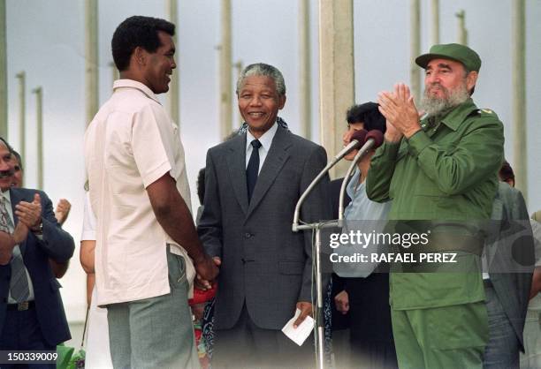 African National Congress President Nelson Mandela greets Cuban Olympic boxer Teofilo Stevenson 25 July 1991 in Havana. Cuban President Fidel Castro...