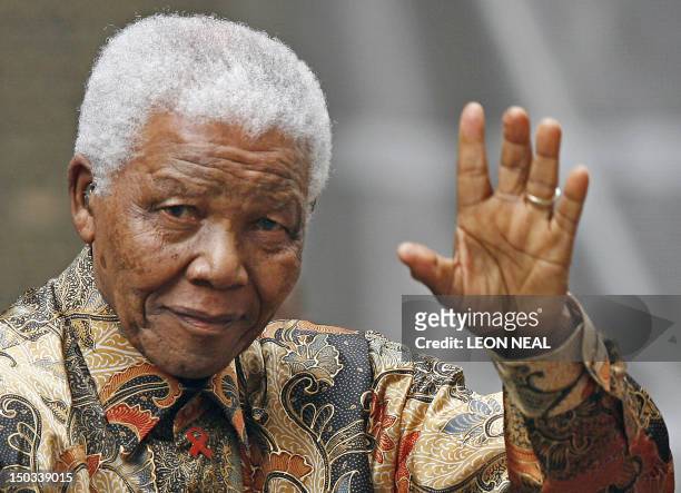 Former South African President Nelson Mandela waves to the media as he arrives outside 10 Downing Street, in central London, 28 August 2007, for a...
