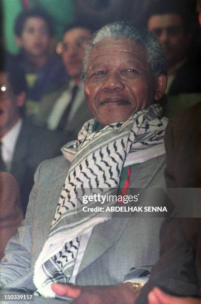 South African anti-apartheid leader and African National Congress member Nelson Mandela , wearing a keffieh, attends a meeting organized in his...