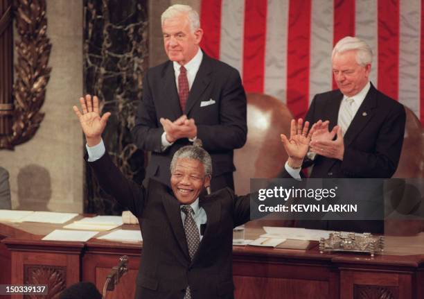 South African anti-apartheid leader and African National Congress member Nelson Mandela raises his arms to acknowledge applause from members of the...