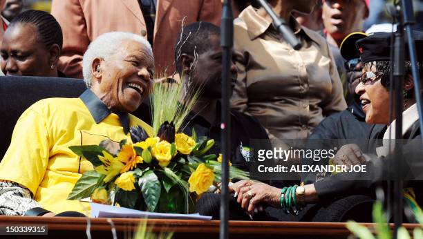 Former South African President Nelson Mandela is greeted by his former wife Anti-apartheid campaigner Winnie in Johannesburg at Ellis Park stadium on...