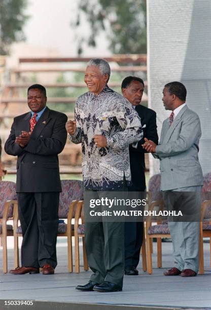 South African President Nelson Mandela dances during the signing ceremony of the country's new constitution at Sharpeville stadium on December 10,...