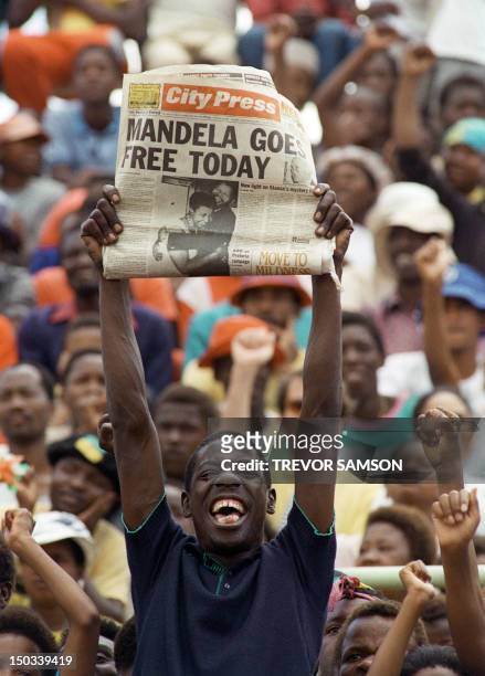 Jubilant Sowetan holds up 11 February 1990 in Soweto a newspaper announcing the release of anti-apartheid leader and African National Congress member...