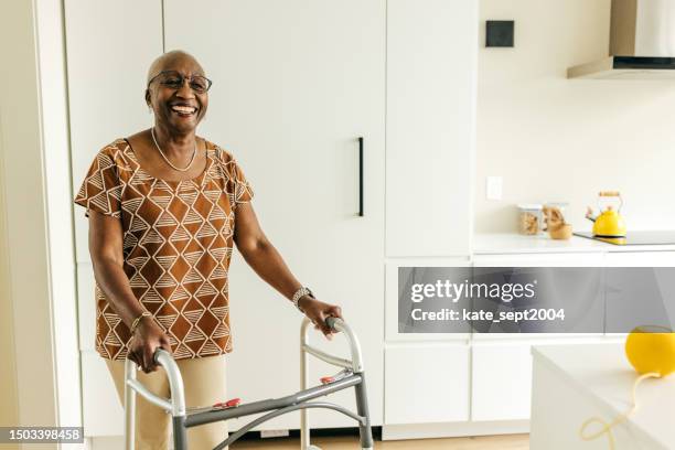 smiling senior women with limited mobility - mobility walker stock pictures, royalty-free photos & images