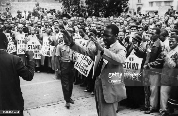 Supporters pray in front of the courthouse of Johannesburg, 28 December 1956, to support 156 anti-apartheid militants, among them Nelson Mandela,...