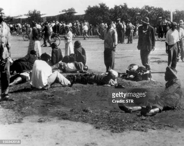 Wounded people lie in the street, 21 March 1960 in Sharpeville, near Vereeniging, where at least 180 black Africans, most of them women and children,...