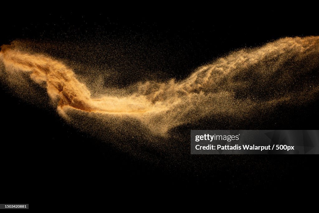 Close-up of sand on sand against black background,Thailand