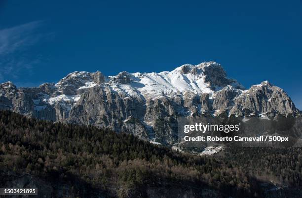 scenic view of snowcapped mountains against clear blue sky,molveno,trento,italy - trentino stock pictures, royalty-free photos & images