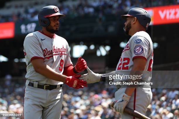 Jeimer Candelario of the Washington Nationals celebrates his run with Dominic Smith during the first inning against the Seattle Mariners at T-Mobile...