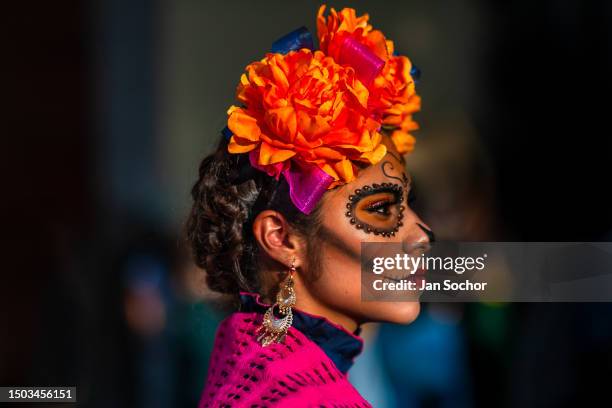 Young Mexican woman, dressed as La Catrina, a Mexican pop culture character representing the Death, takes part in the Day of the Dead festivities on...
