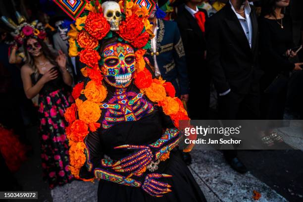 Mexican woman, dressed as La Catrina and wearing Huichol beaded mask and dress, takes part in the Day of the Dead festivities on November 1, 2022 in...