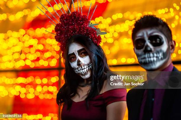 Young Mexican woman, dressed as La Catrina, and a young Mexican man, dressed as Catrín, take part in the Day of the Dead celebrations on November 1,...