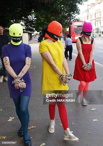 Three Amnesty International activists dressed as the Russian Band Pussy Rioters outside the Russian Embassy in London on August 12, 2012 protest for...