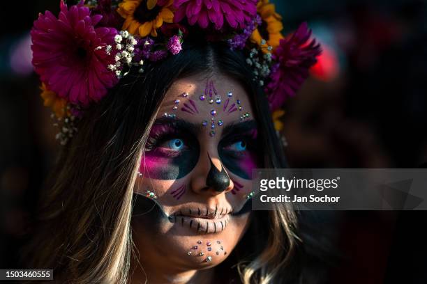 Young Mexican woman, dressed as La Catrina, a Mexican pop culture character representing the Death, takes part in the Day of the Dead celebrations on...