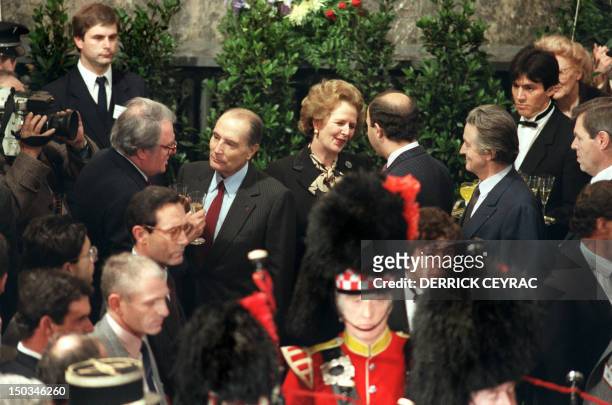 French President François Mitterrand chats with city of Lille's Mayor Pierre Mauroy and British Prime Minister Margaret Thatcher confers with future...