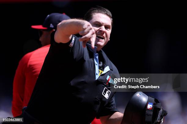 Umpire Derek Thomas throws manager Dave Martinez of the Washington Nationals out of the game against the Seattle Mariners during the sixth inning at...