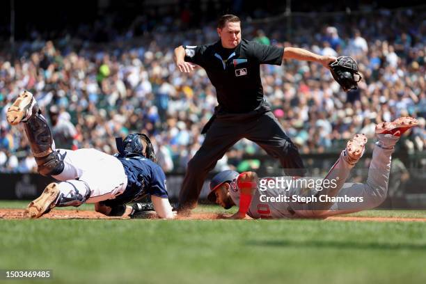 Umpire Derek Thomas calls Keibert Ruiz of the Washington Nationals out at home plate against Tom Murphy of the Seattle Mariners during the sixth...
