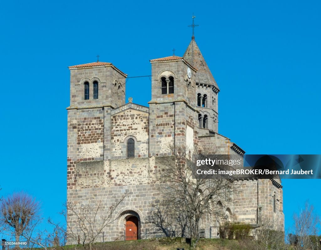 Romanesque church of Saint Nectaire, Puy de Dome departement, Auvergne-Rhone-Alpes, France, blue sky, winter, brickwall