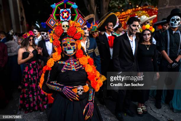 Mexican woman, dressed as La Catrina and wearing Huichol beaded mask and dress, takes part in the Day of the Dead celebrations on November 1, 2022 in...
