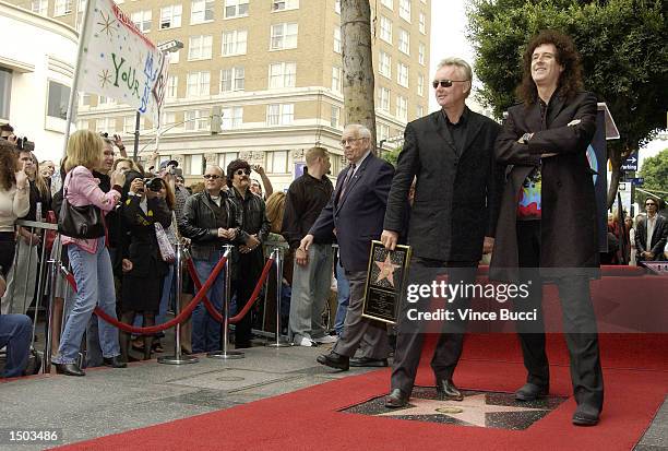 Drummer Roger Taylor and guitarist Brian May of the rock group Queen attend a ceremony honoring the British band with a star on the Hollywood Walk of...