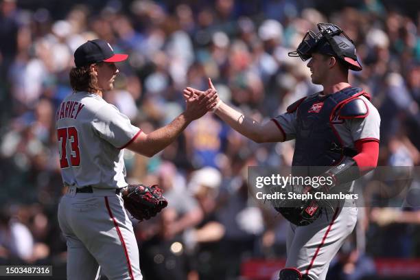 Hunter Harvey celebrates with Riley Adams of the Washington Nationals after their 4-1 win against the Seattle Mariners at T-Mobile Park on June 28,...